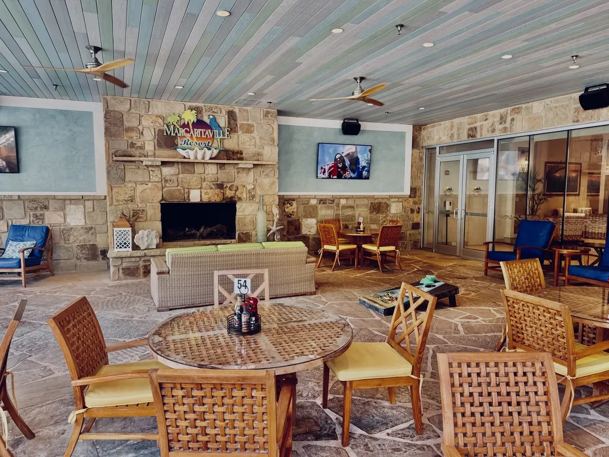 outdoor tables, chairs, tvs, and games like cornhole