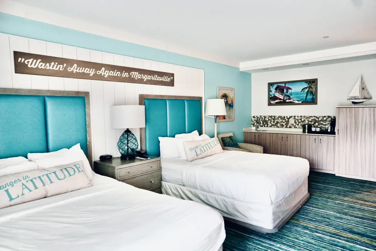 hotel room view of two beds with island decor