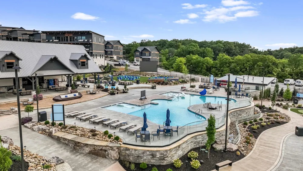 Pool area with lounge chairs and landscaping