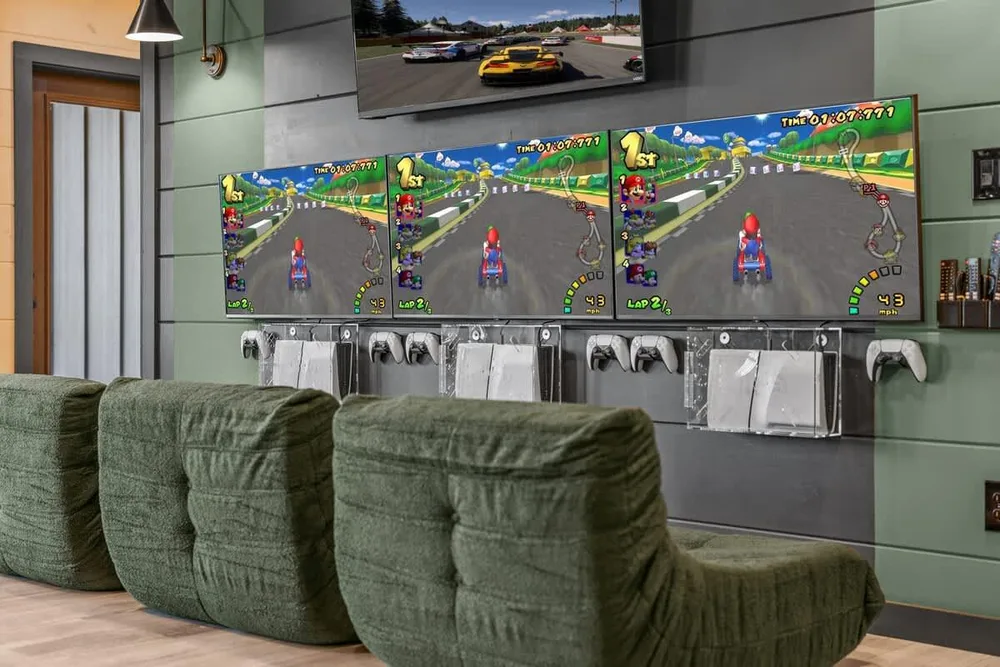 Gaming area with multiple TVs and consoles