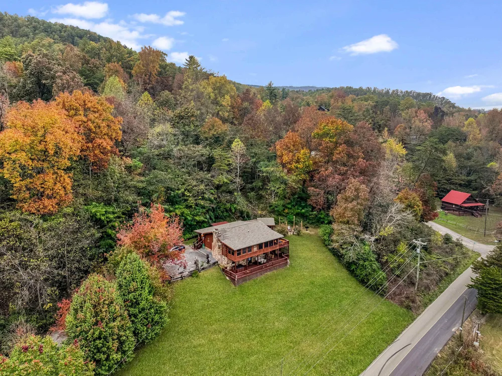 Wooded cabin surrounded by autumn foliage