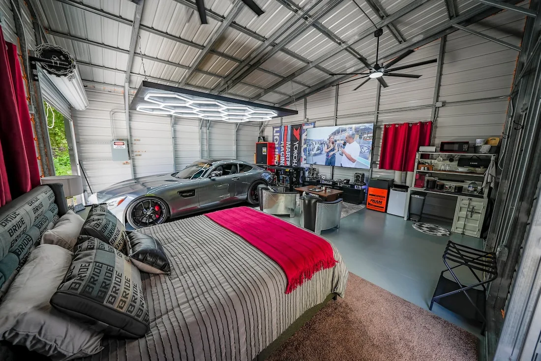 Inside it is one open studio — a bed, a lounge, and room to roll a car in