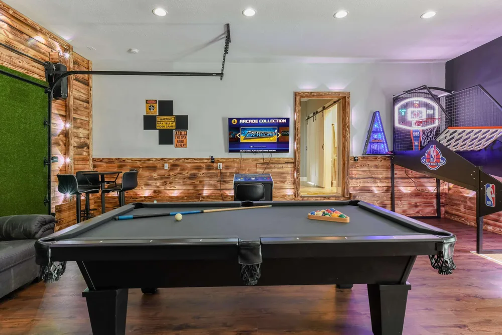 Game room with pool table and arcade
