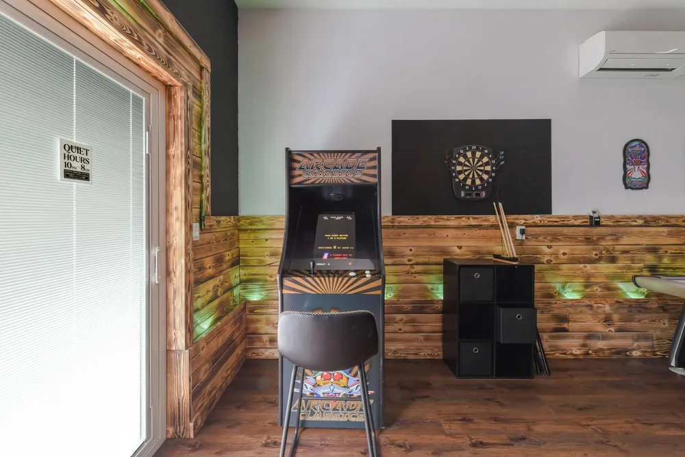 Game room with arcade cabinet and darts