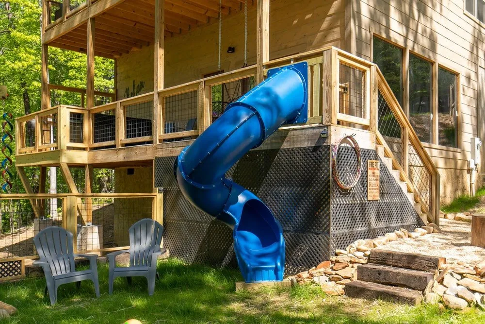 Cabin with outdoor slide and seating area