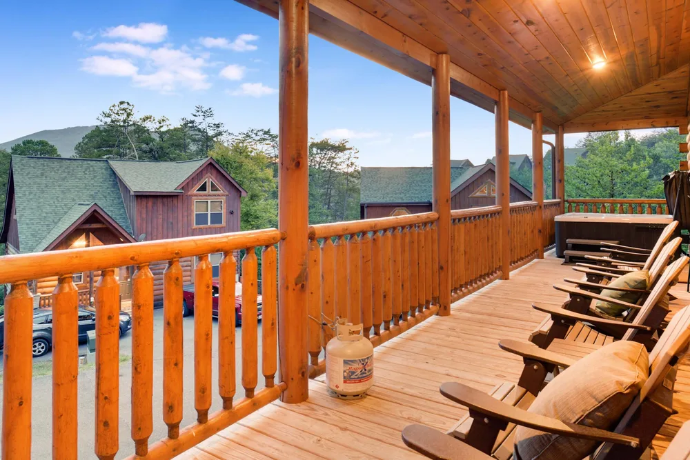 Covered porch overlooking neighboring cabins