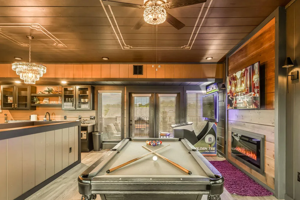 Game room with pool table and fireplace