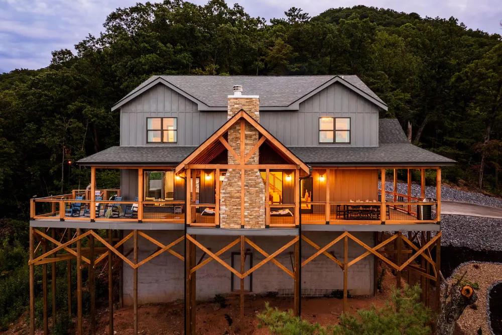 Modern cabin elevated on stilts in woods