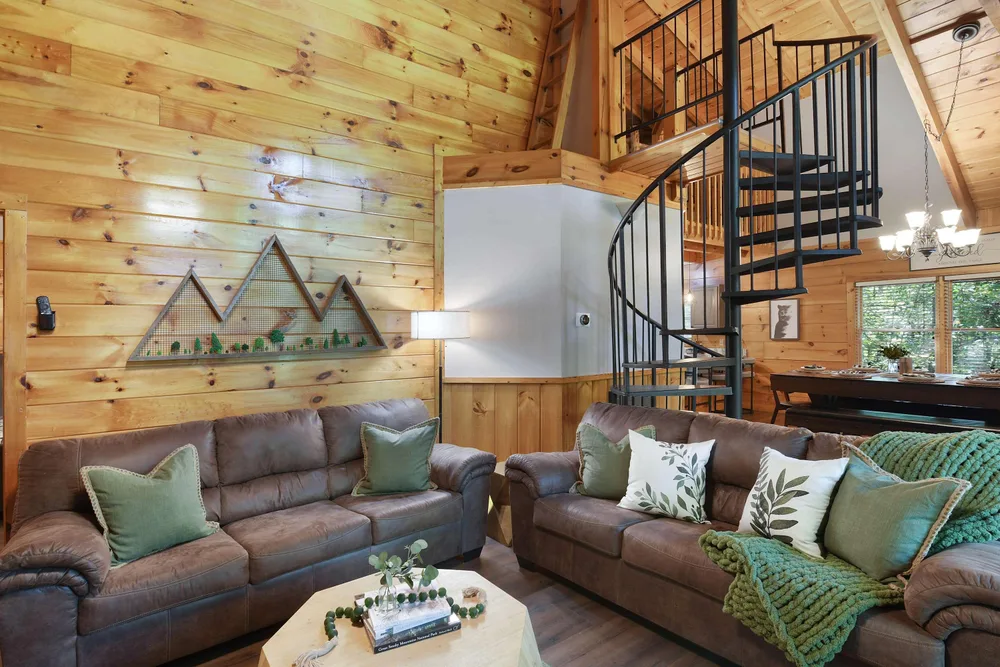 Cozy cabin living room with spiral staircase