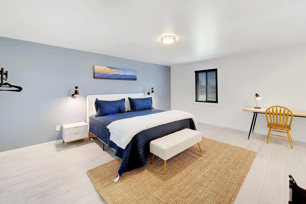 Modern bedroom with desk and seating