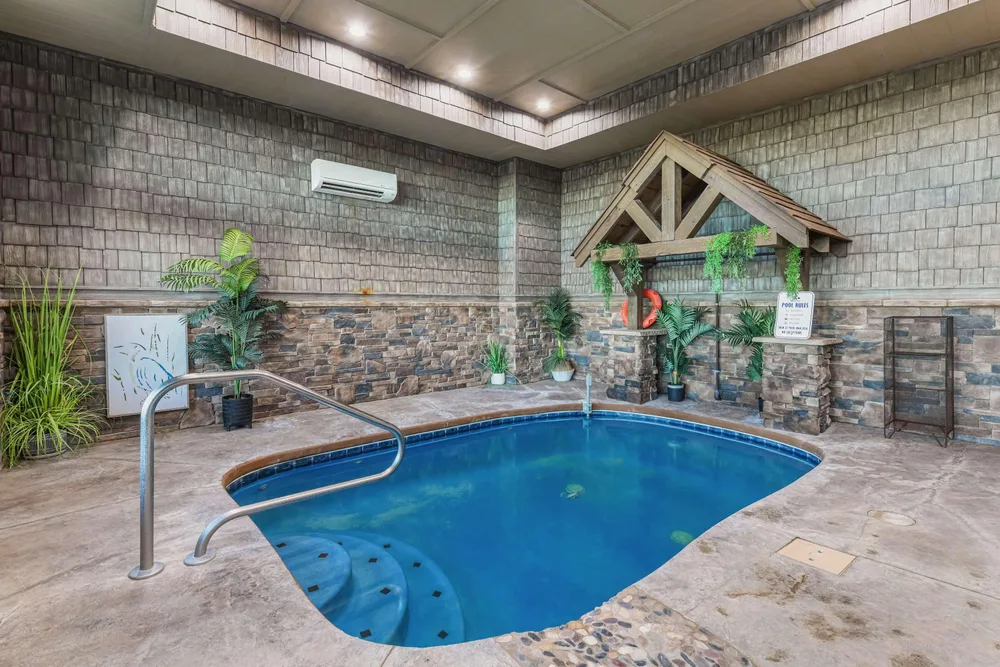 Indoor pool with stone walls and greenery