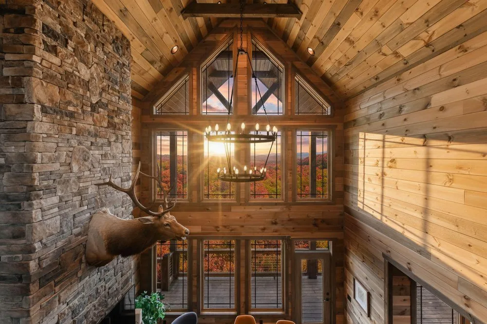 Two-story cabin with stone accent wall