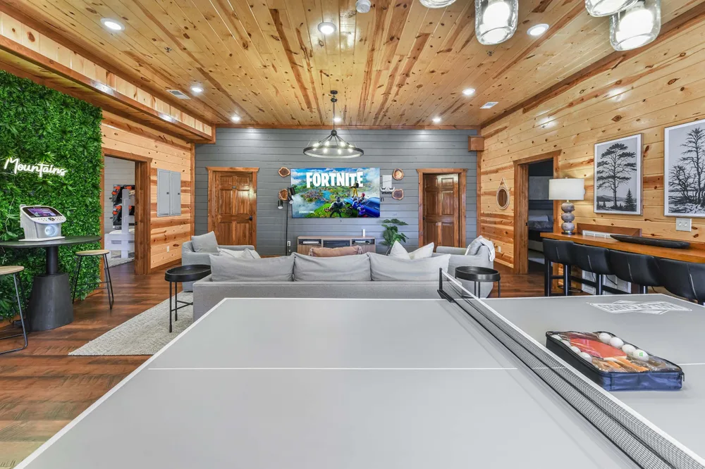 Game room with ping pong table and TV