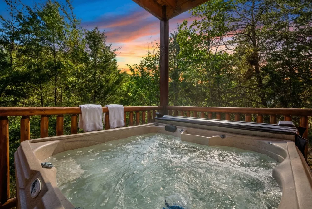 Hot tub with forest view at sunset