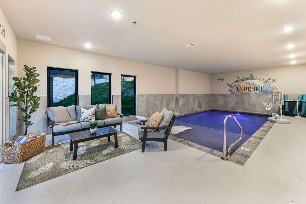 Indoor pool area with seating and decor