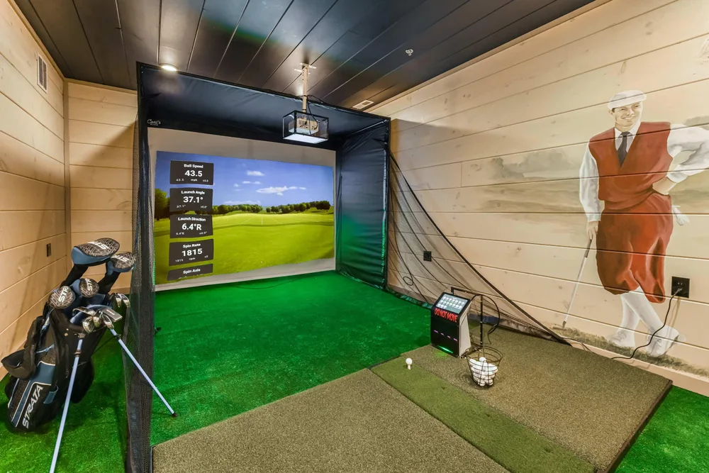 Indoor golf simulator with hitting area