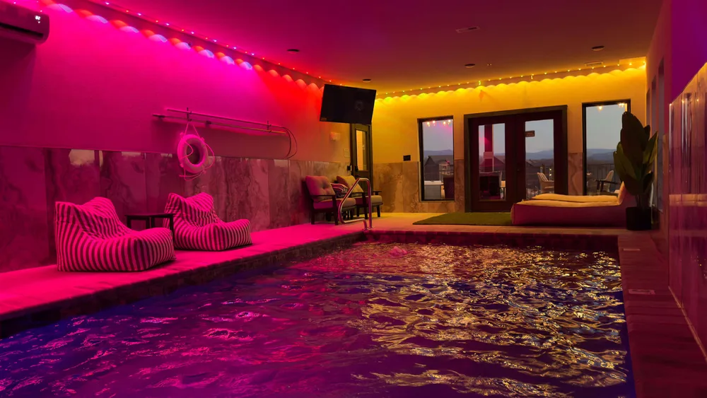 Indoor pool with colorful lighting setup
