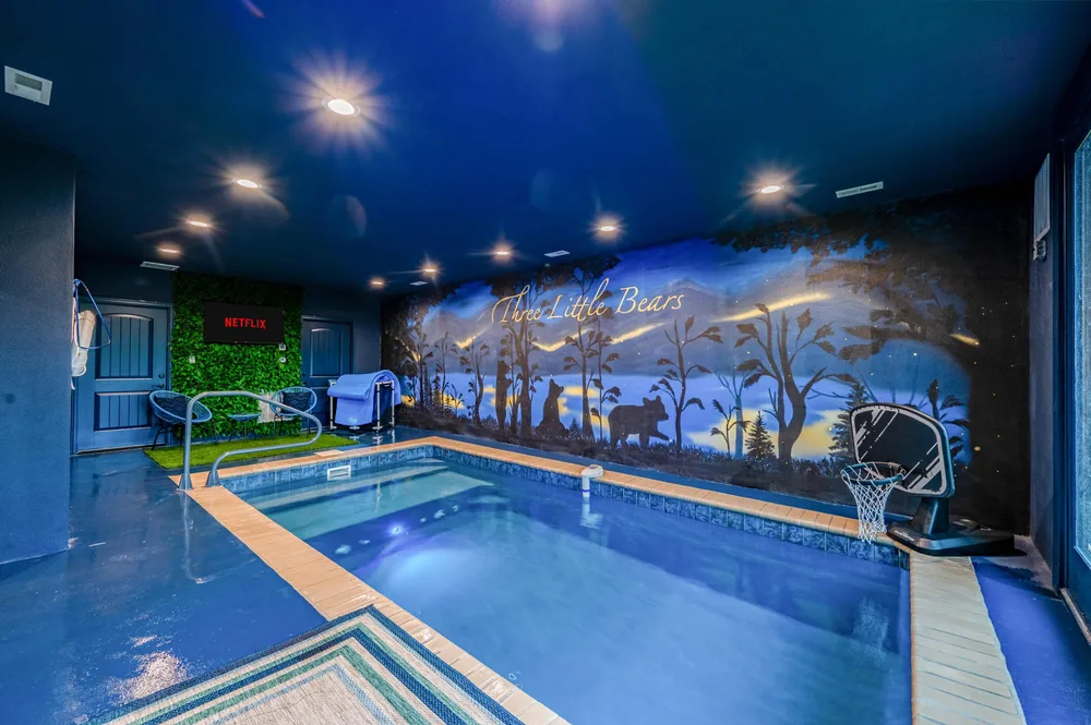 Indoor pool with mural and seating
