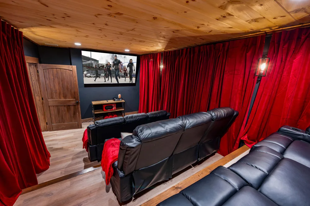 Home theater with red curtains and seating
