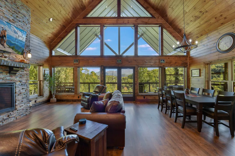 Spacious cabin living area with mountain view