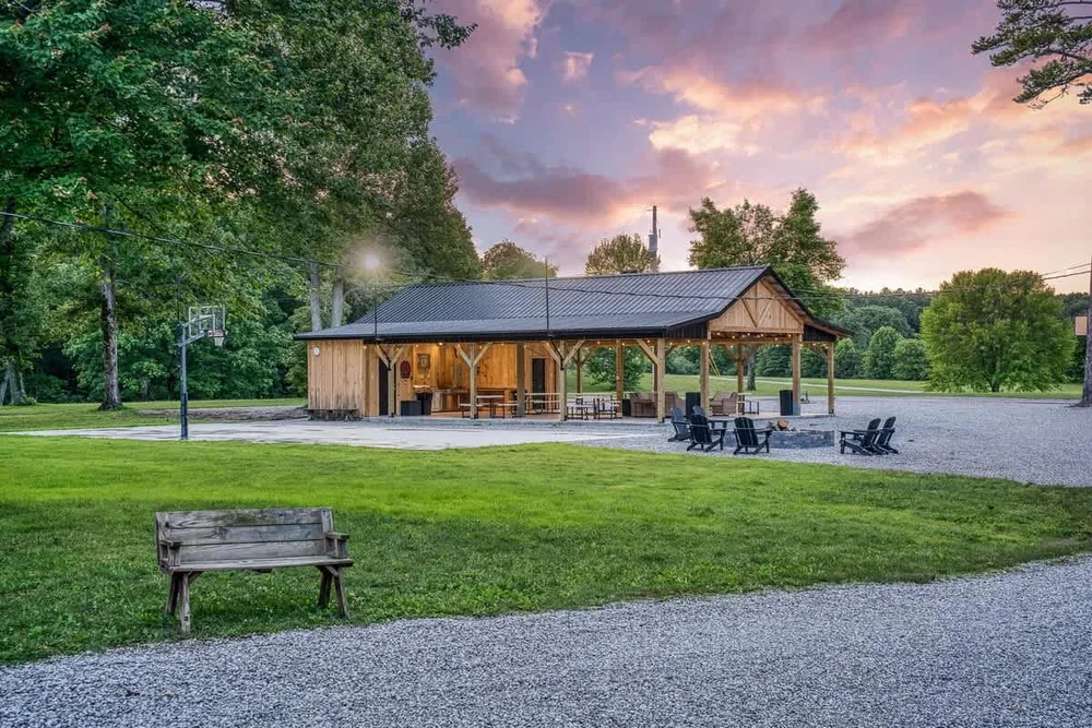 Open pavilion surrounded by green landscape
