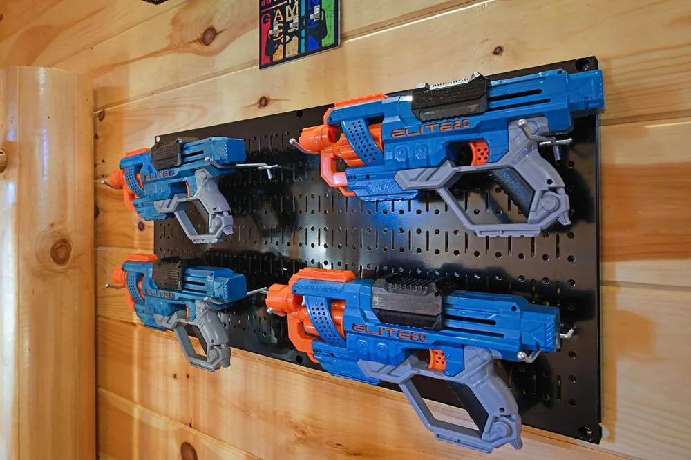 Wall-mounted collection of toy blasters