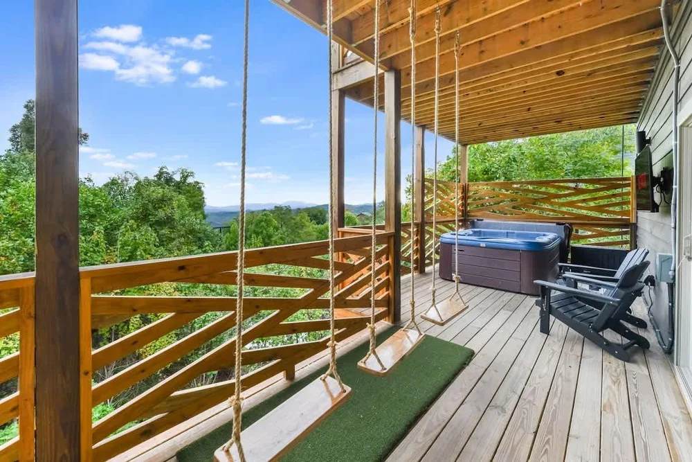 Covered porch with swings and hot tub